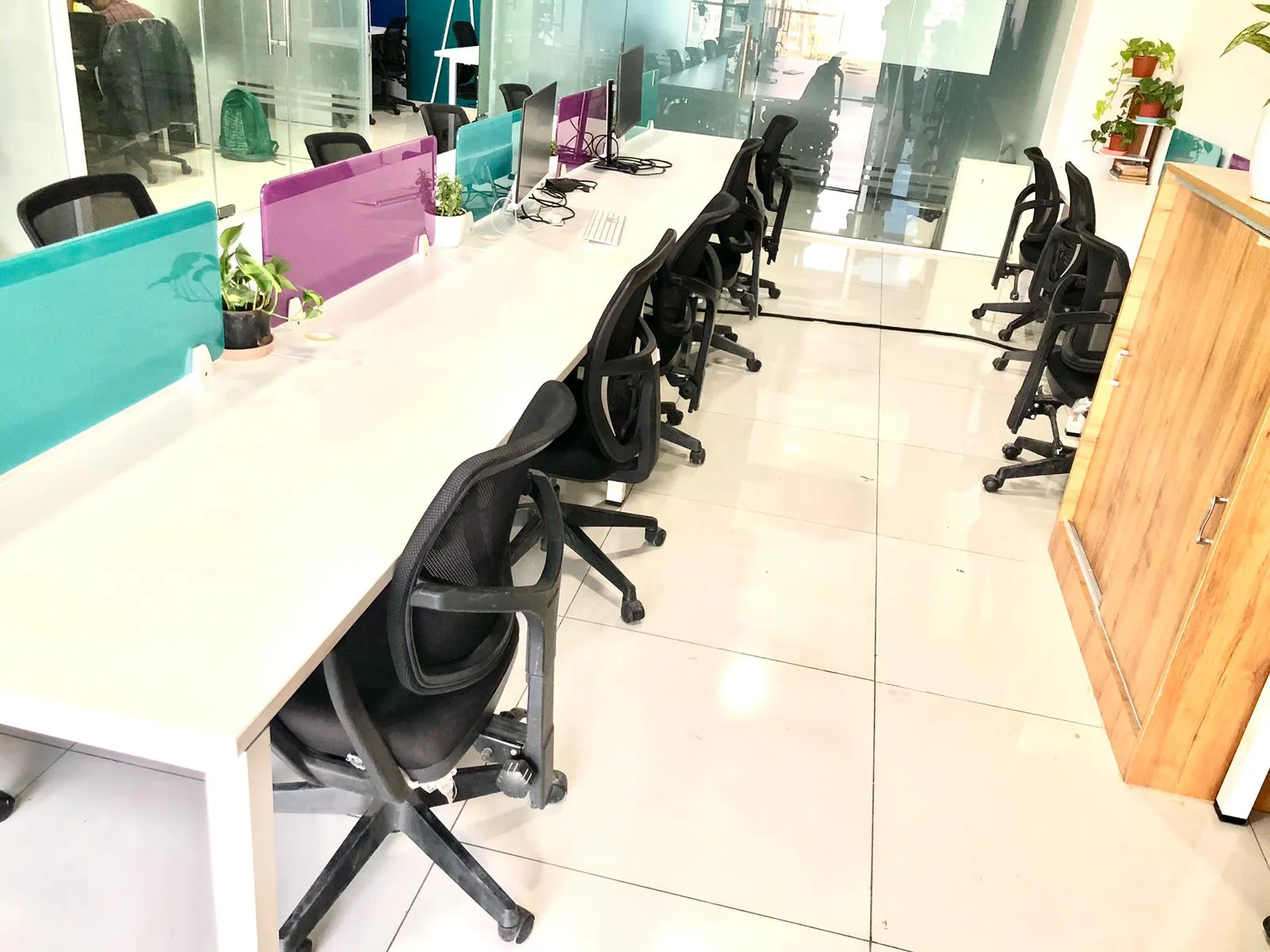 Shared workspace area at The Living Desk Pune